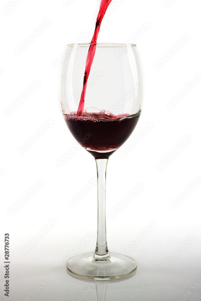 Pouring red wine into a glass Pouring red wine into a glass