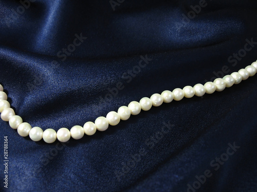 pearls on background the dark blue silk