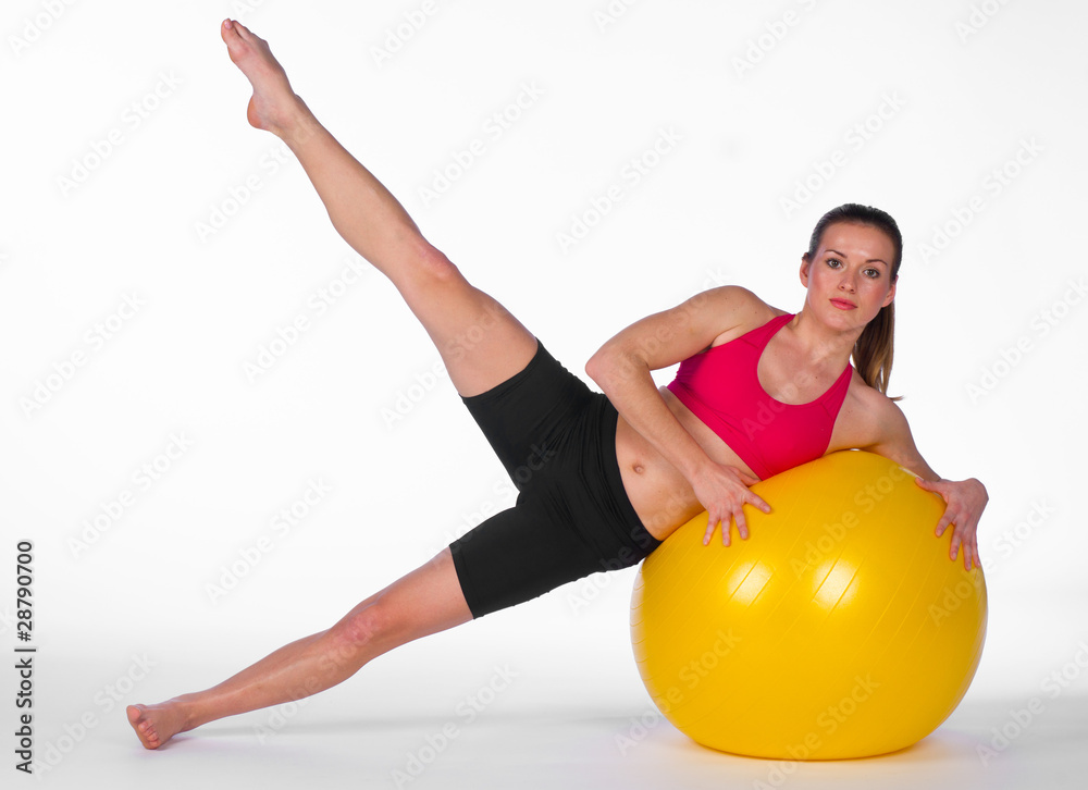 young woman exercise on pilates ball young woman exercise on pilates ball