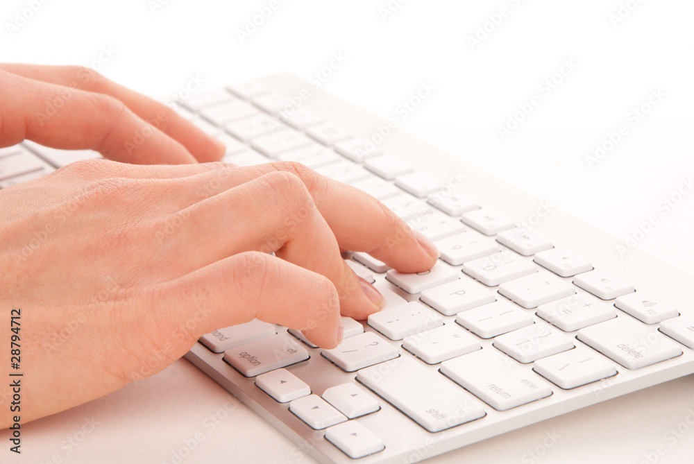 Hands typing on the remote wireless computer keyboard Hands typing on the remote wireless computer keyboard