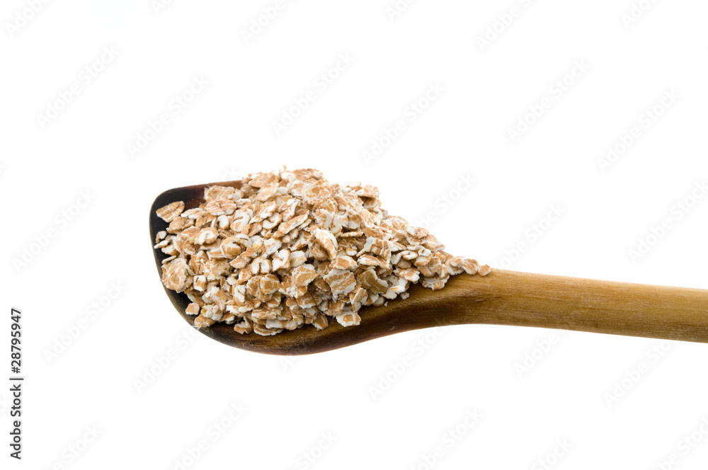 Dinkelflocken auf einem Kochlöffel Dinkelflocken auf einem Kochlöffel