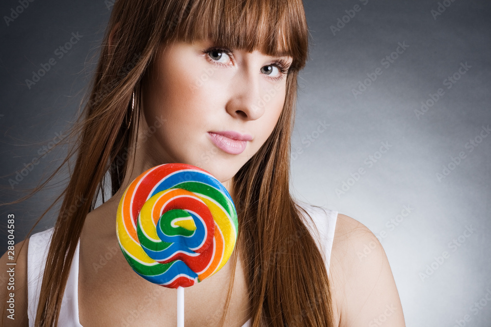 portrait of beautiful girl with big lollipop