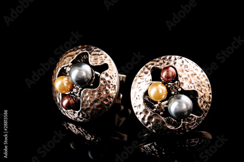 Earrings with pearls isolated on black