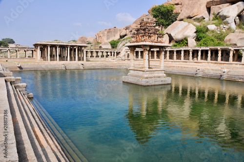 Ancient water pool and temple at Krishna market, Hampi,  India © Noradoa