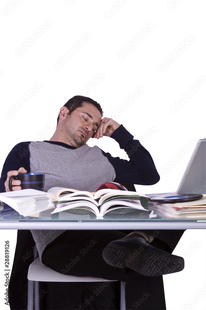 College Student Sleeping on his Desk