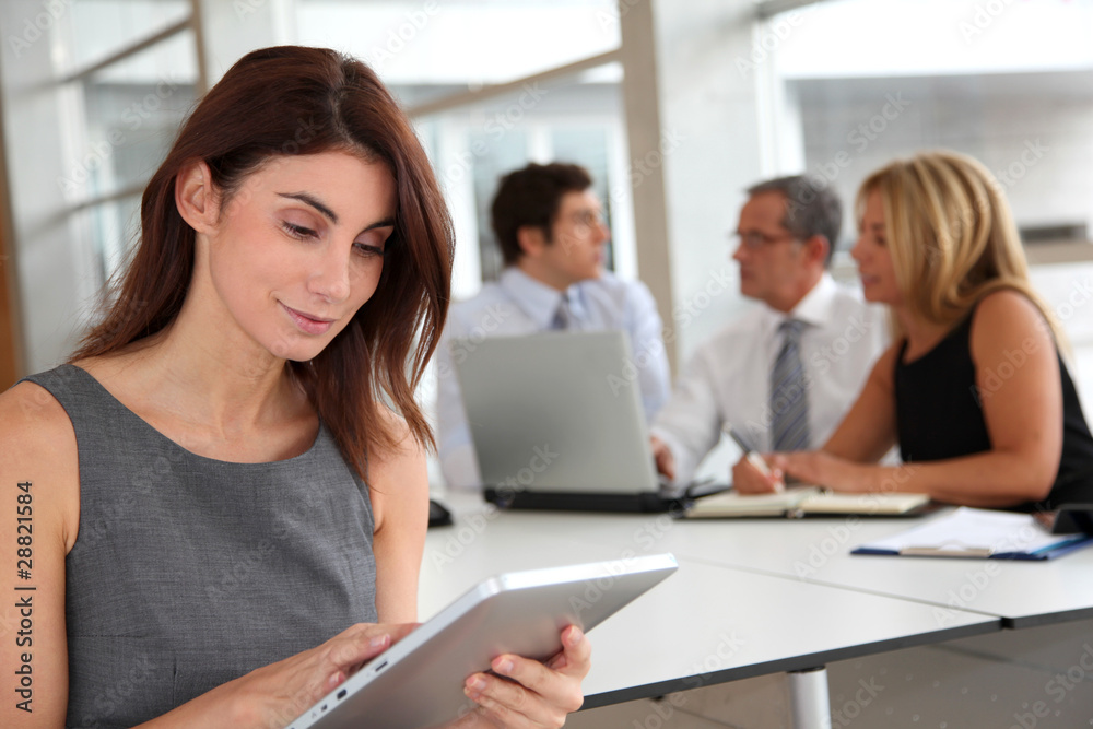 Executive woman working on electronic tab Executive woman working on electronic tab