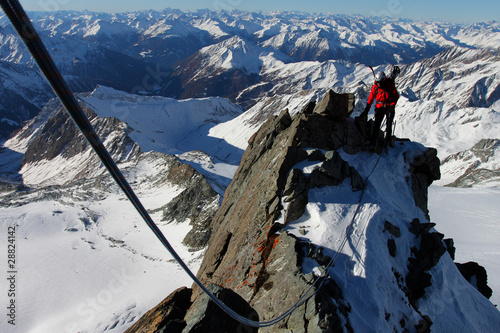 Winter climbing in the Alps. Climber with rope on a ridge.