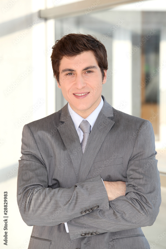 Young businessman standing in hall Young businessman standing in hall