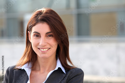 Portrait of businesswoman standing outside