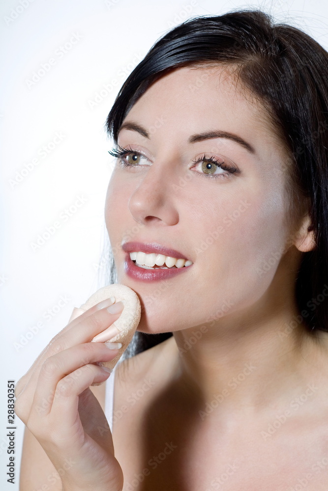 beautiful young woman applying face powder make-up beautiful young woman applying face powder make-up