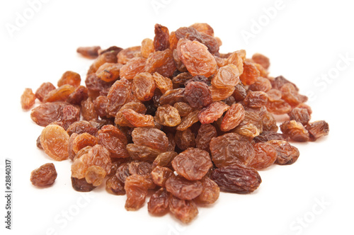 Black dried raisins isolated on white background