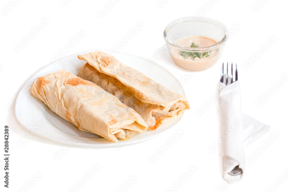 Chicken and vegetables wrapped in a pitta isolated on a white Chicken and vegetables wrapped in a pitta isolated on a white