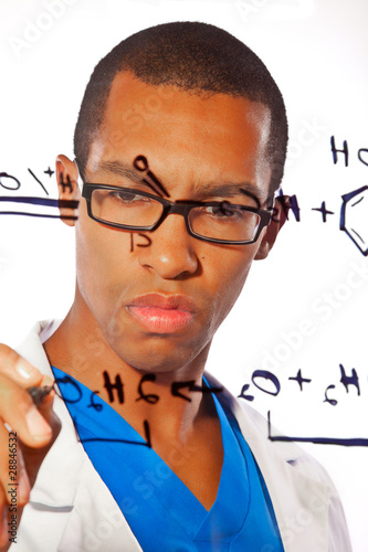 A young scientist works on a chemitsry equation