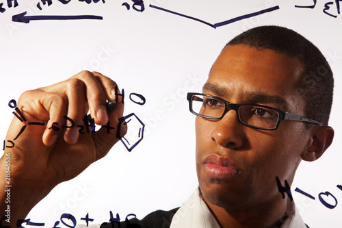 A young man works on a chemistry problem.
