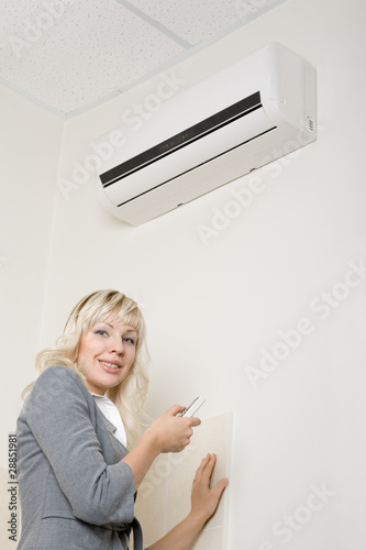 Attractive girl includes air conditioner