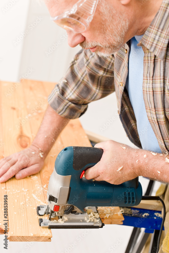 Home improvement - handyman cut wood with jigsaw Home improvement - handyman cut wood with jigsaw