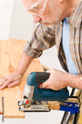 Home improvement - handyman cut wood with jigsaw
