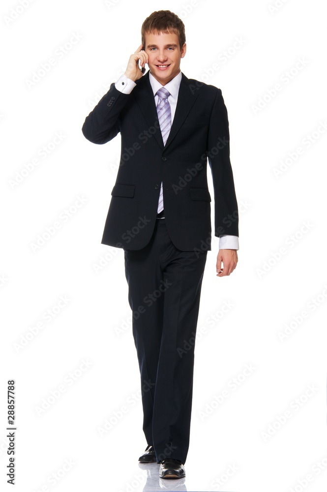 Young businessman talking on mobile phone Young businessman talking on mobile phone