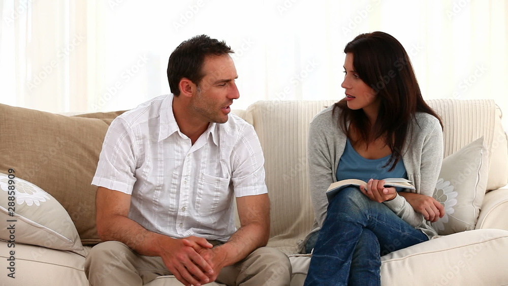Parents talking each other sitting on the sofa Parents talking each other sitting on the sofa