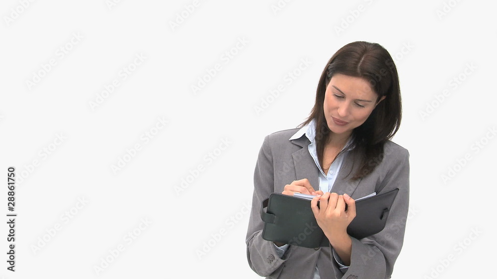 Beautiful businesswoman writing on her agenda Beautiful businesswoman writing on her agenda
