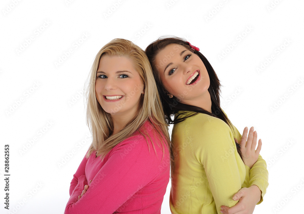 Two pretty female friends having fun and laughing. isolated on w Two pretty female friends having fun and laughing. isolated on w