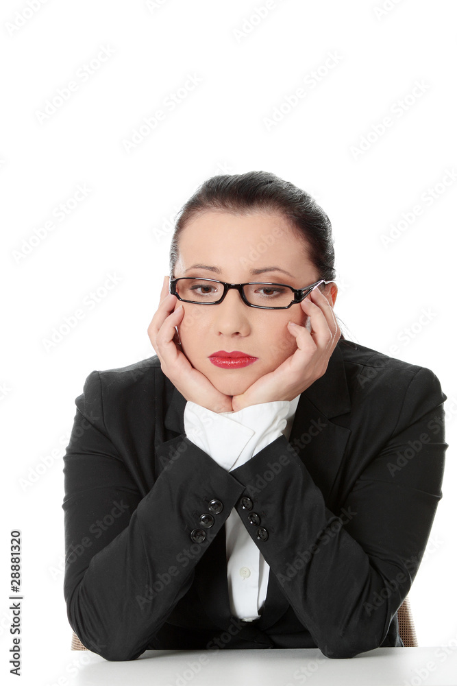 Sad business woman sitting behind the desk Sad business woman sitting behind the desk