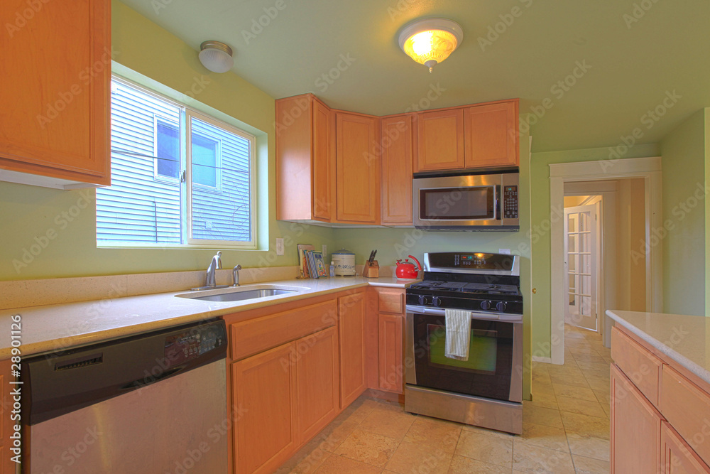 Green kitchen with maple cabinets and black appliances Green kitchen with maple cabinets and black appliances