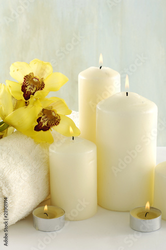 Beautiful orchid with white candle photo