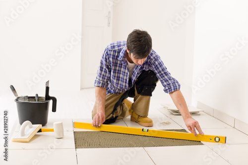 Quadro su tela Home tile improvement - handyman with level