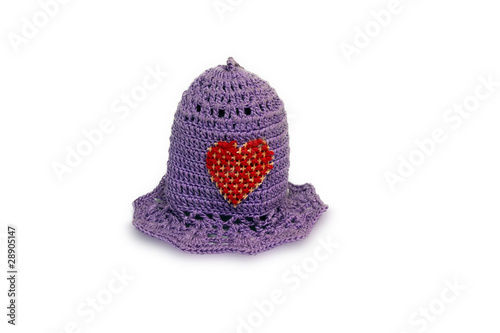 little knitted cap on a white background with a Heart photo