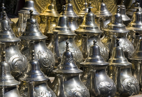 Silver and brass teapots