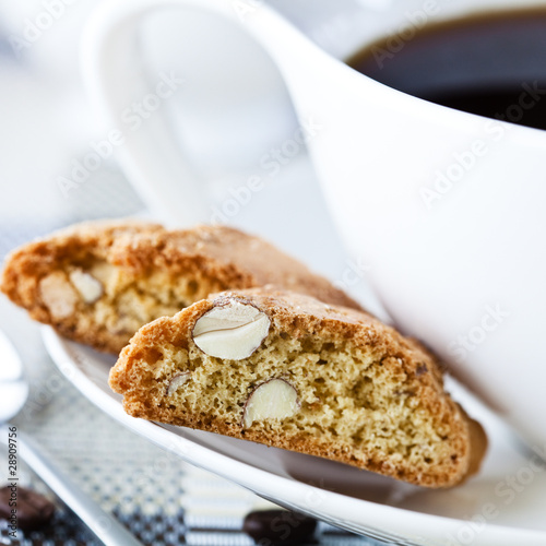 Closeup of two cantuccinis and a cup of coffee