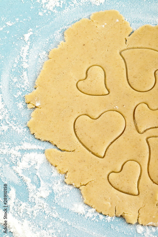 Making heart shaped shortbread cookies with cutters, dough Making heart shaped shortbread cookies with cutters, dough