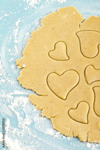 Making heart shaped shortbread cookies with cutters, dough