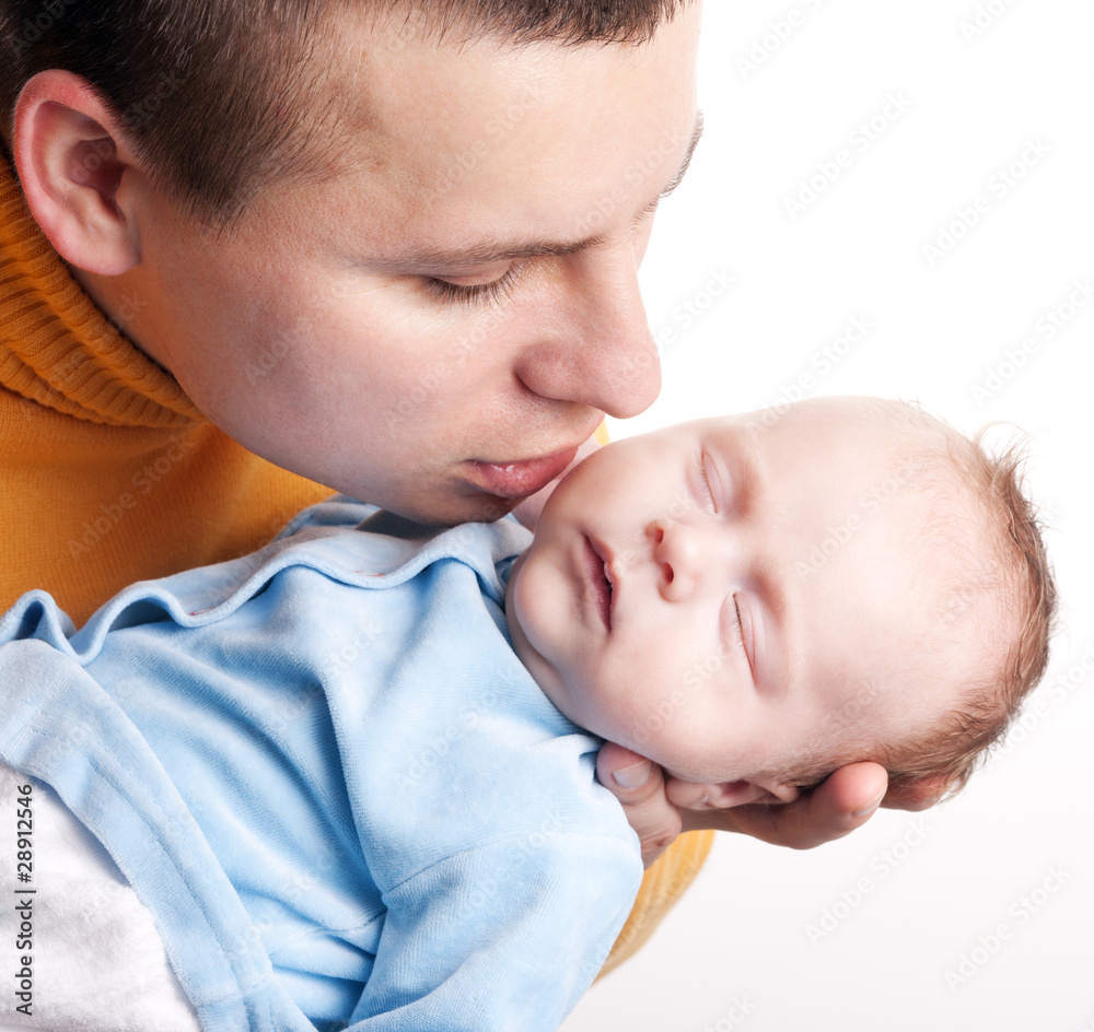Father kisses his newborn baby Father kisses his newborn baby