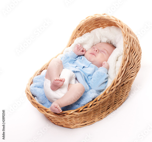 New born baby sleeps in basket