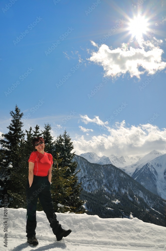 Winter portrait of senior woman in mountain snowy land