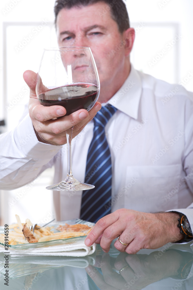man at restaurant looking glass of red wine man at restaurant looking glass of red wine
