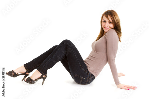 young woman sitting on floor isolated on white