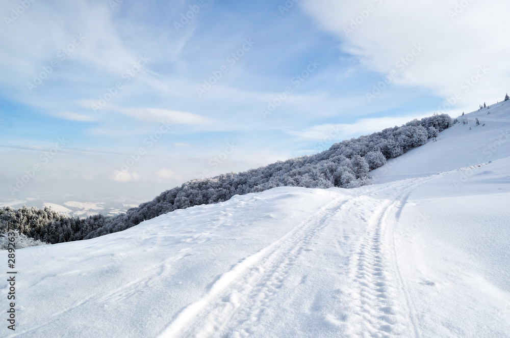 Winter road running onto hill top