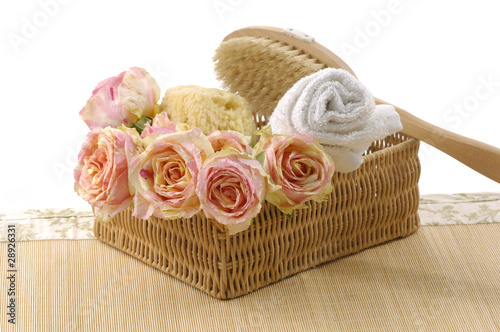 Spa essentials (bath accessories and rose petals in basket )