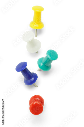 Multicolor push pins arranged in a row on white background