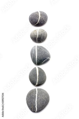 Row of assorted pebbles isolated on a white