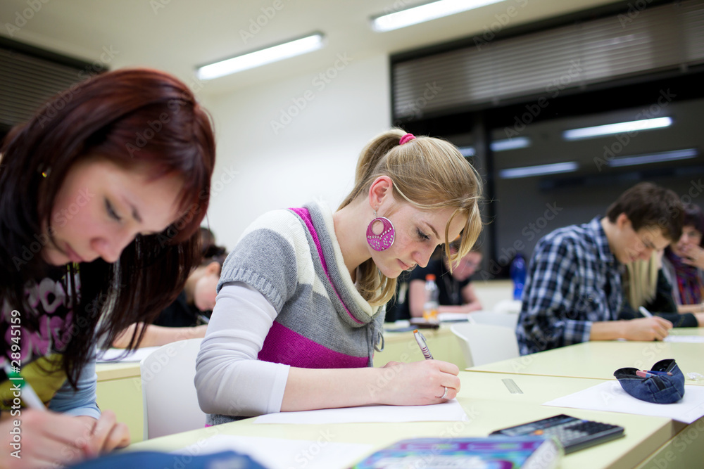 pretty female college student sitting in a classroom pretty female college student sitting in a classroom