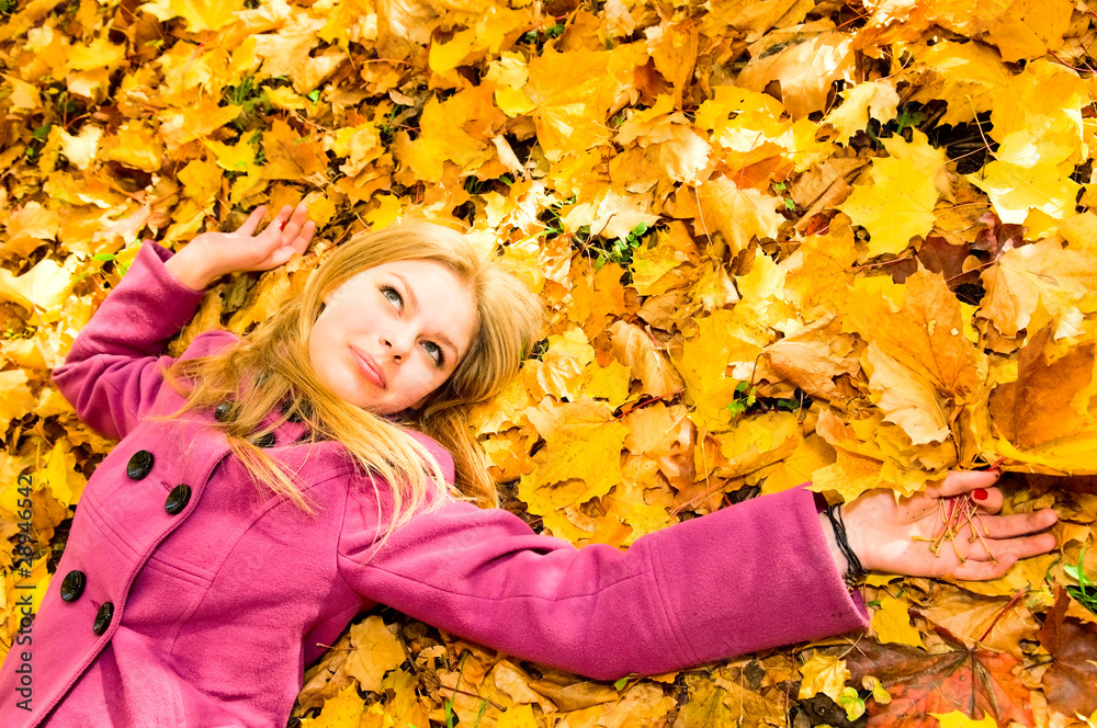 young woman resting on the autumn leaves