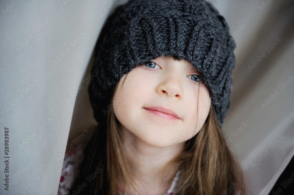 Adorable kid girl in dark grey hat