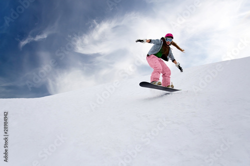 Girl rider jump on snowboard