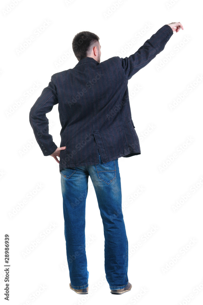 young man pointing at wall. rear view. young man pointing at wall. rear view.
