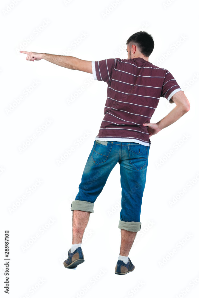 young man pointing at wall. rear view. young man pointing at wall. rear view.