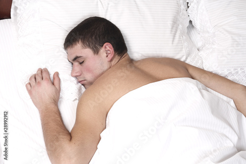 a young boy sleeping in bed